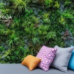 Artificial living wall with couch with decorative pillows