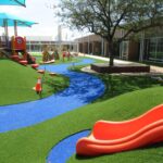 Artificial playground grass with orange slide