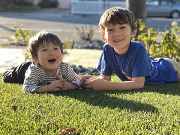 Kids relaxing on artificial grass