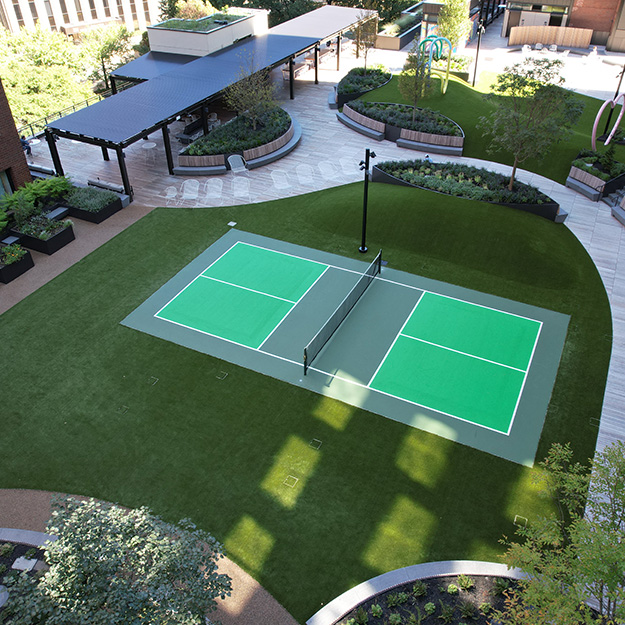 Artificial grass tennis court with sport surfacing