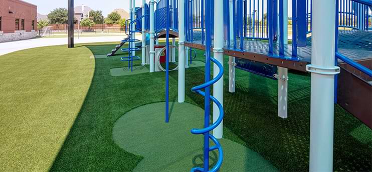 Blue playground equipment on synlawn artificial grass